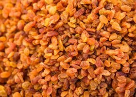 Top view of a heap of dried golden raisins, perfect for culinary and healthy eating visuals.