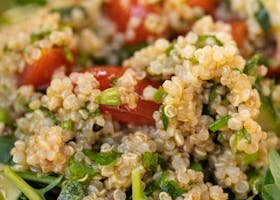 Vibrant quinoa salad with cherry tomatoes, greens, perfect for healthy eating.